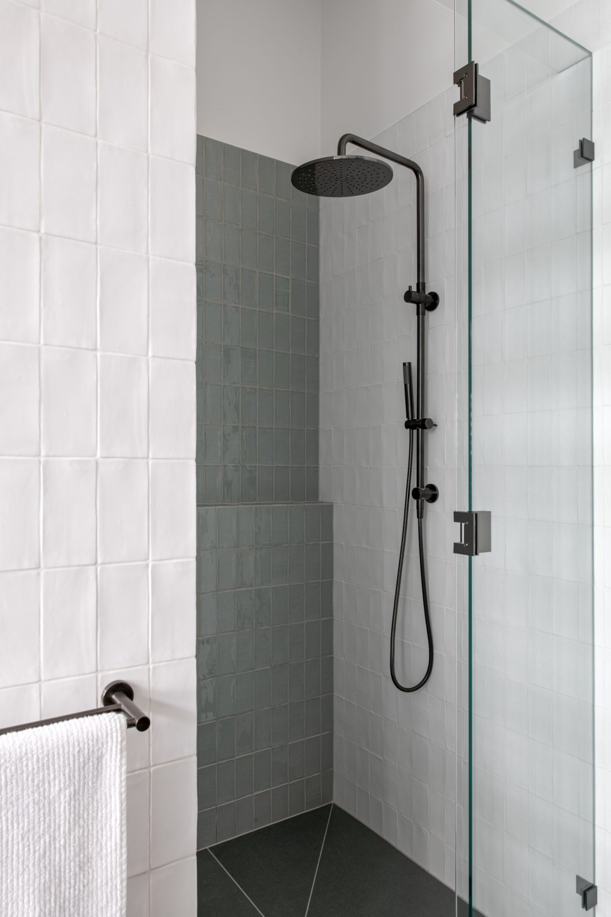 A custom designed bathroom featuring green and white tiles. Designed and built by MJ Harris Group.