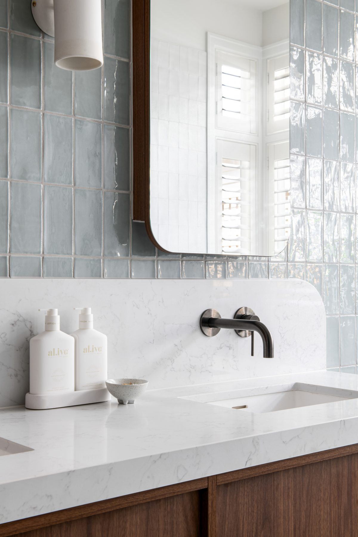 A custom designed bathroom featuring Spanish handmade look tiles. Designed and built by MJ Harris Group.