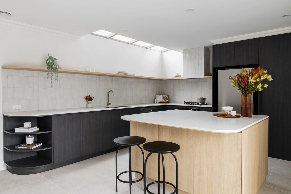 A custom designed kitchen featuring splashback tiles and contemporary curves. Designed and built by MJ Harris Group. #MJHxAndrewSt