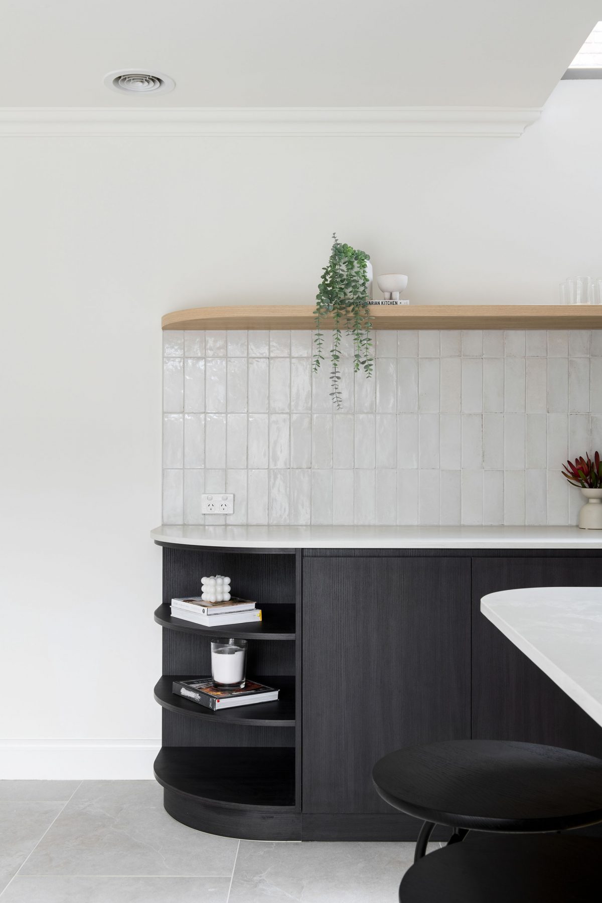 A custom designed kitchen featuring splashback tiles and contemporary curves. Designed and built by MJ Harris Group. #MJHxAndrewSt