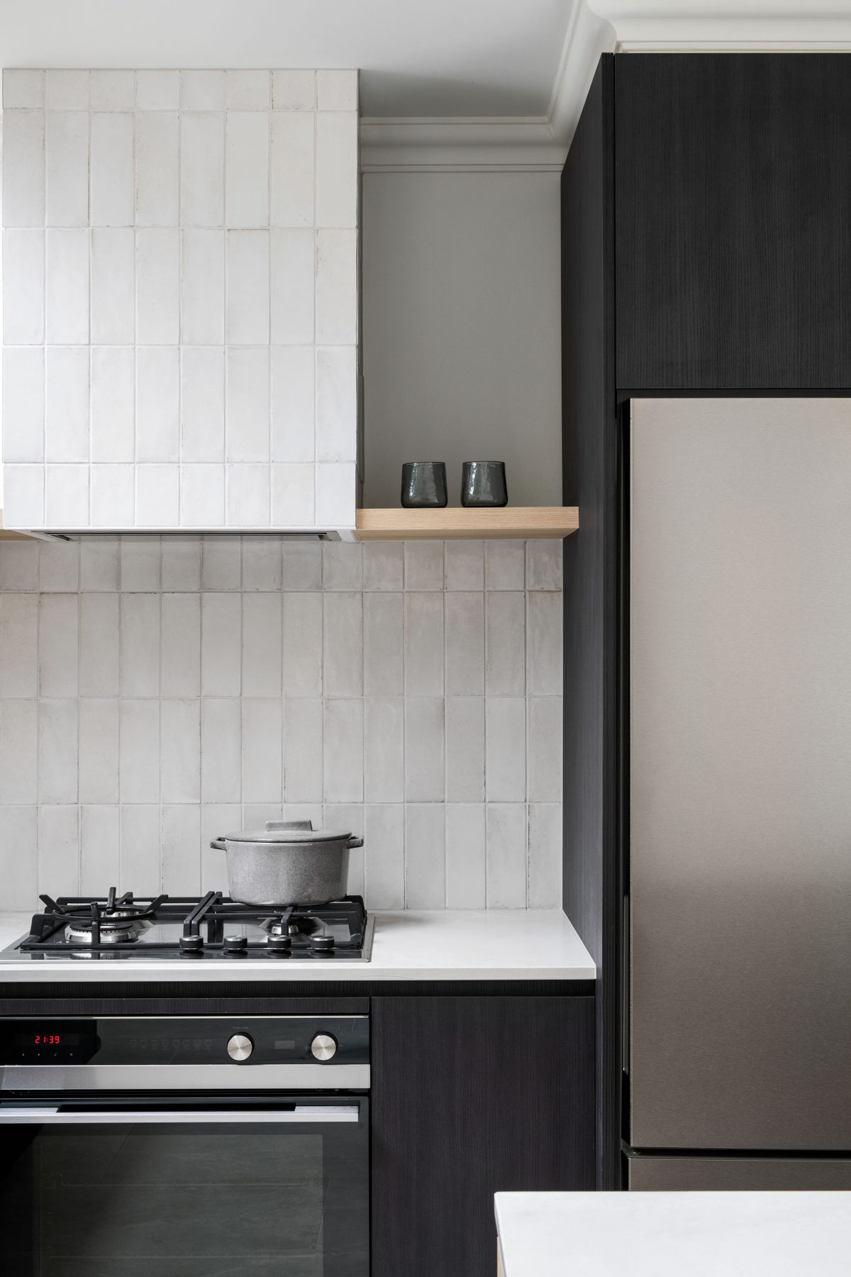 A custom designed kitchen featuring splashback tiles and contemporary curves. Designed and built by MJ Harris Group. #MJHxAndrewSt