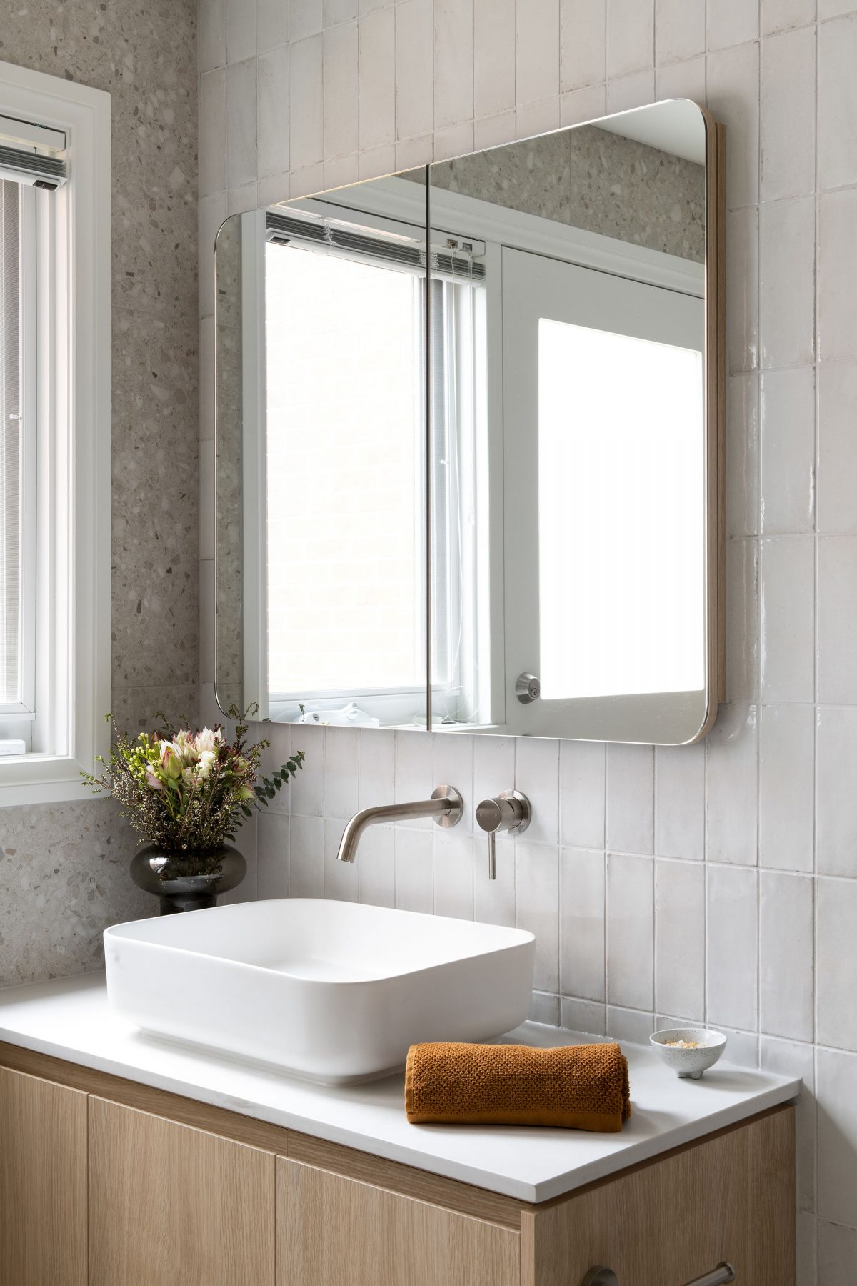 A custom designed bathroom featuring beige terrazzo. Designed and built by MJ Harris Group. #MJHxAndrewSt