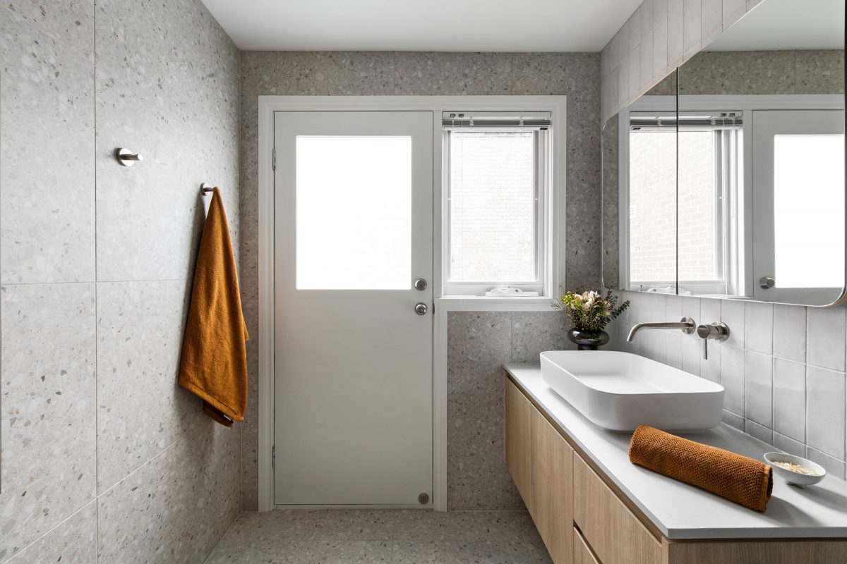 A custom designed bathroom featuring beige terrazzo. Designed and built by MJ Harris Group. #MJHxAndrewSt